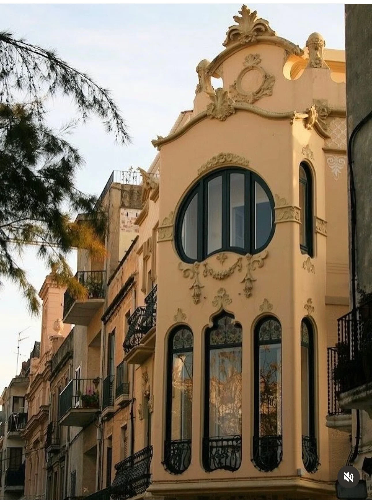 Art Nouveau facade of Hotel Noucentista in Sitges glowing at sunset