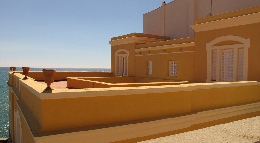 Terrasse d'un café à l'ombre d'un olivier dans une ruelle de la vieille ville de Sitges