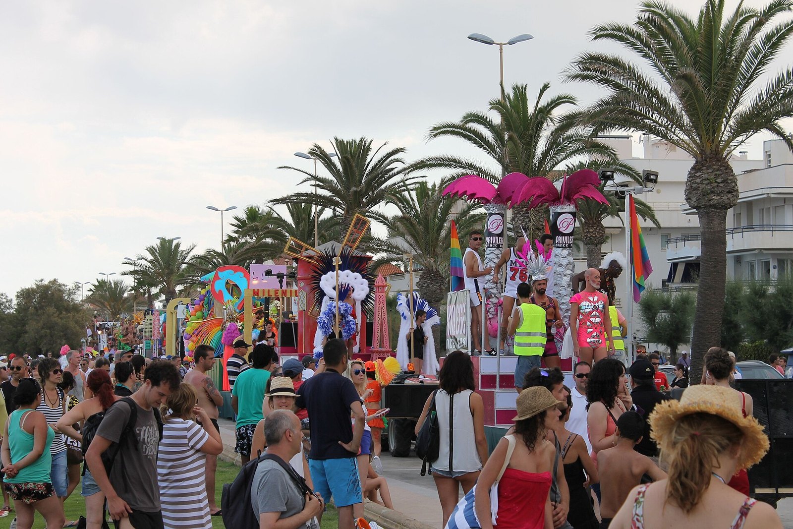 Sitges Gay Pride atmosphere, rainbow flags and a celebrating crowd along the seafront