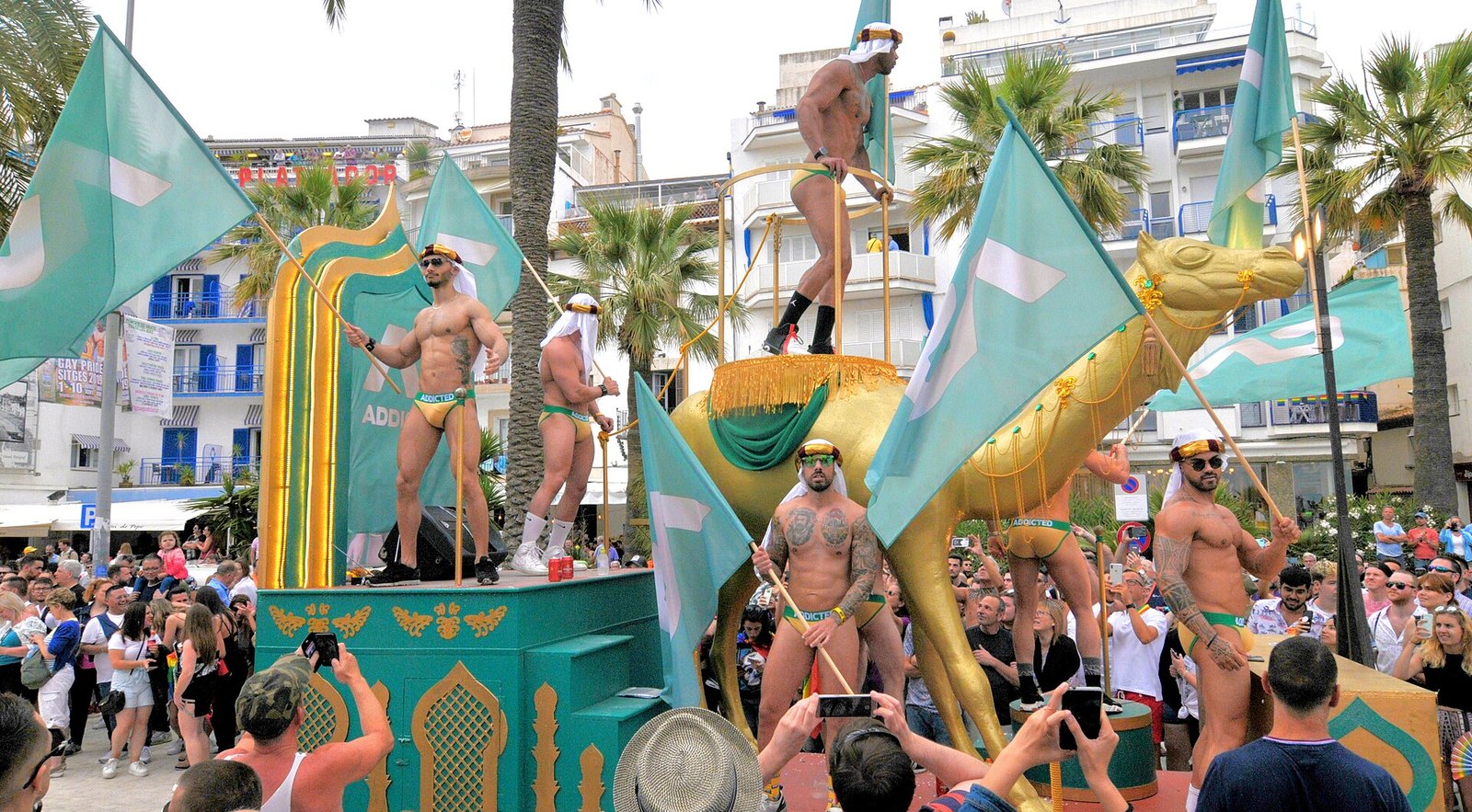Sitges Gay Pride parade on the seafront, floats and a festive crowd