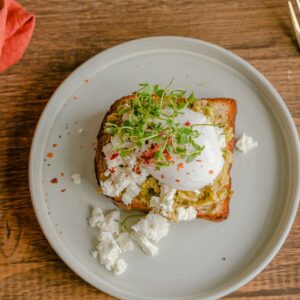 Sunlit Mediterranean brunch table in Sitges with eggs, toast and coffee
